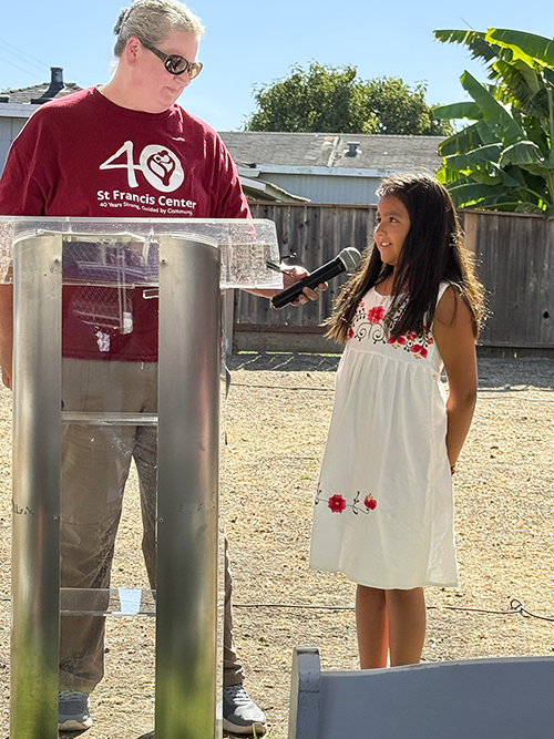 A young girl who lives in the North Fair Oaks neighborhood shares her excitement about playing in the Magical Bridge Pocket Park with Kate Young, Executive Director of St. Francis Center. A young girl who lives in the North Fair Oaks neighborhood shares her excitement about playing in the Magical Bridge Pocket Park with Kate Young, Executive Director of St. Francis Center.