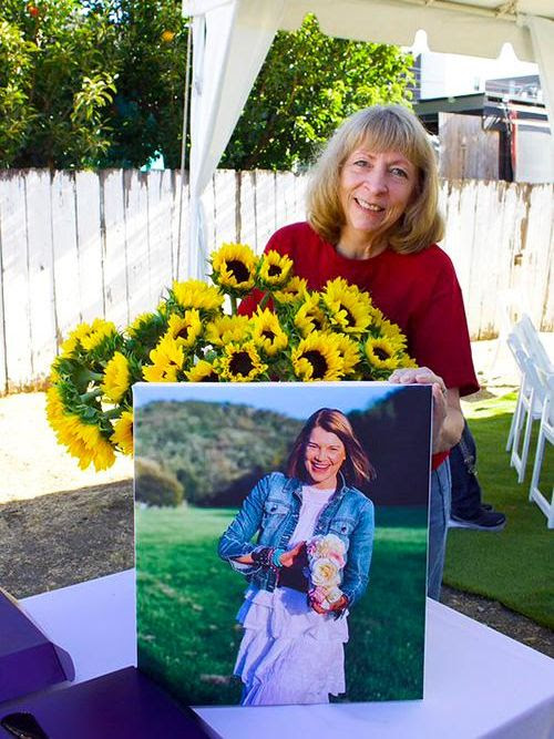 Attendees were invited to take a sunflower in honor of Tess Weber. A portion of the park will be dedicated to her memory. Pictured here is Kathleen Hamilton, Teacher, Holy Family School. Attendees were invited to take a sunflower in honor of Tess Weber. A portion of the park will be dedicated to her memory. Pictured here is Kathleen Hamilton, Teacher, Holy Family School.